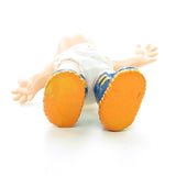 Magic Diapers Baby figurine wearing blue sneakers