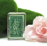 Soldered brooch with 1958 Gardening postage stamp
