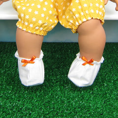 White baby doll booties with orange bow