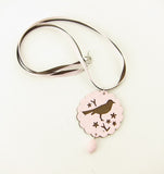 Pink and brown pendant necklace with bird and egg